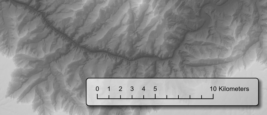 The same scale bar on the same map, now sitting on a pale, partly transparent rounded rectangle with a thin dark outline and a soft dark shadow along its right and lower edges, where every line and number is easy to read