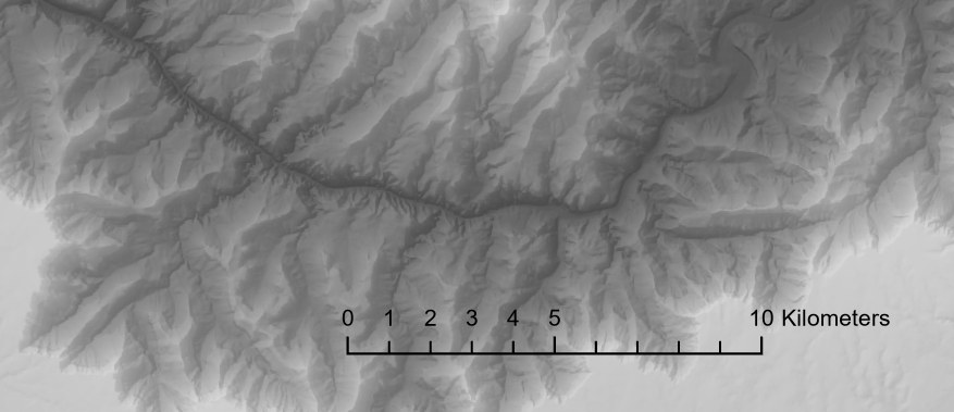 A black scale bar reading 0 to 10 kilometers drawn directly over a gray shaded elevation map, where its lines and numbers are hard to make out against the terrain