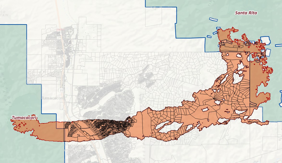 The corridor between the Tumacacori and Santa Rita blocks filled with clipped parcel polygons: a dense mass of tiny lots at the western end near the highway, large irregular parcels through the middle, and a block of rectangular parcels toward the Santa Rita end