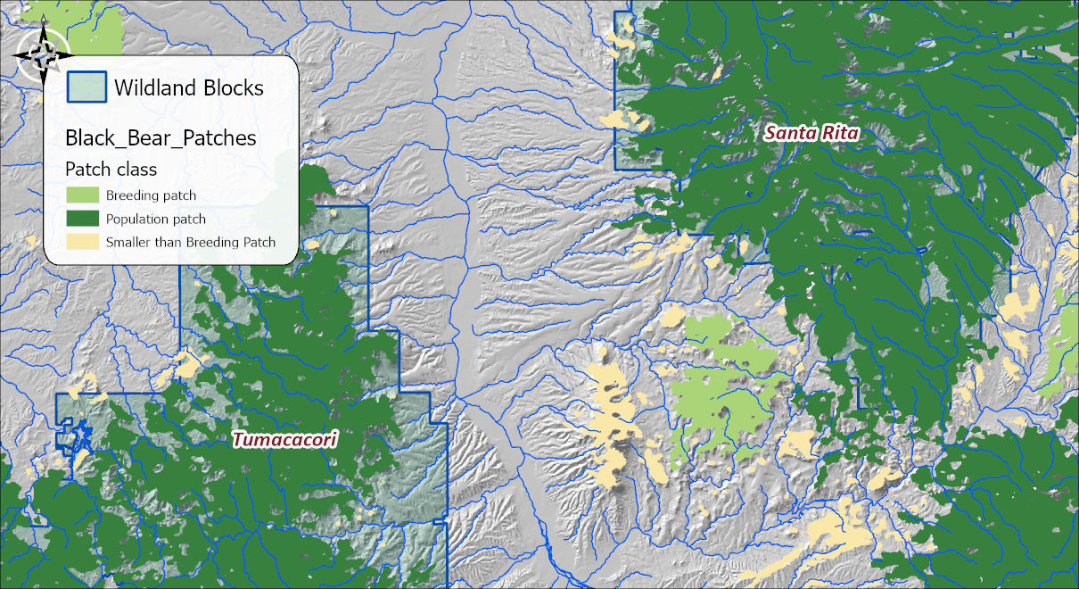 The patch map over a hillshade: large dark-green population patches filling both wildland blocks, a few light-green breeding patches in the hills between them, and small pale-yellow patches too small for breeding scattered across the valley