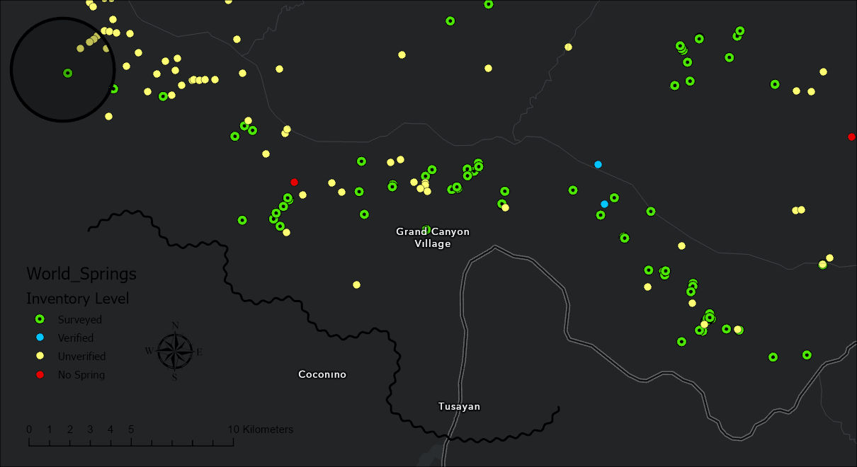 A layout with a dark gray basemap of the Grand Canyon Village area, scattered green, yellow, blue and red spring symbols, and in black, barely visible against the dark ground: a legend titled World_Springs with four inventory levels, a compass north arrow, a scale bar in kilometers, a circle around a cluster of springs at the upper left, and a wavy freehand line
