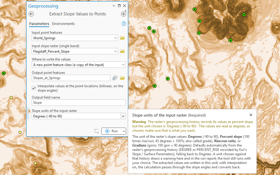The Extract Slope Values to Points pane over a map of springs on the slope raster, with Slope units of the input raster changed to Degrees (-90 to 90) and a warning icon beside it; the parameter's help pop-up reads: Warning. The raster's geoprocessing history records its values as percent slope, but the unit chosen is 'Degrees (-90 to 90)'. The values are read as degrees, as chosen; make sure that is what you want.