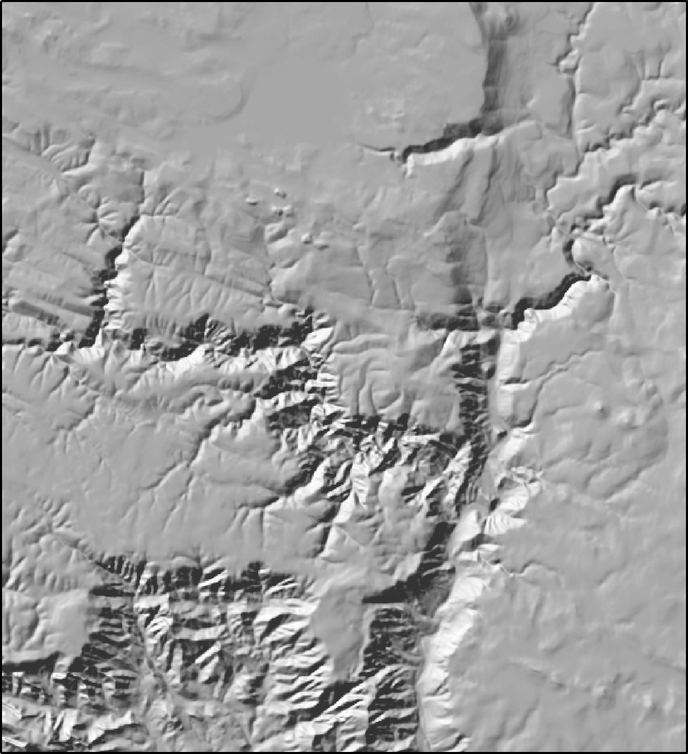 The same hillshade of Oak Creek Canyon lit from the northwest: the canyon and its side canyons now read as dark gorges cut down into the plateau