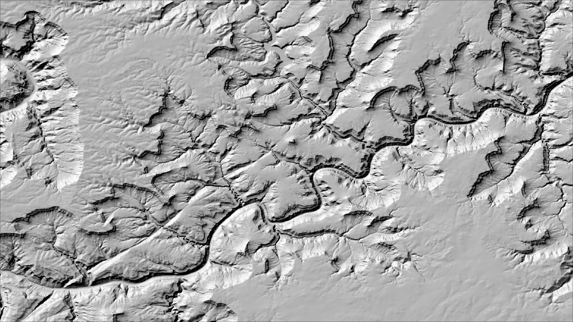 The south-lit hillshade of the canyon system rotated 180 degrees, so that the light now falls from the upper left of the image: the canyon again reads as a gorge cut below the plateau