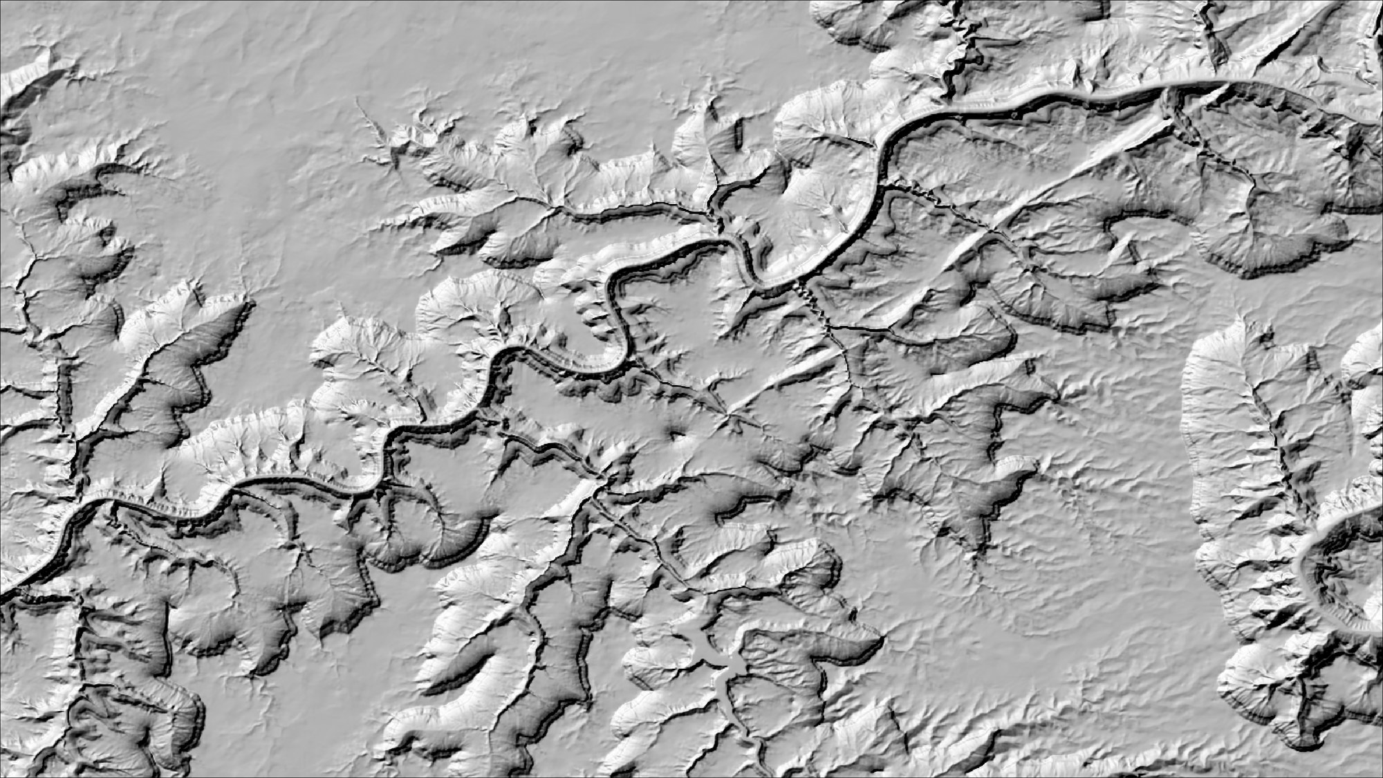 The same canyon system with the sun in the southeast: to most eyes the relief now appears inverted, the canyon reading as a raised ridge system standing above the surrounding plateau