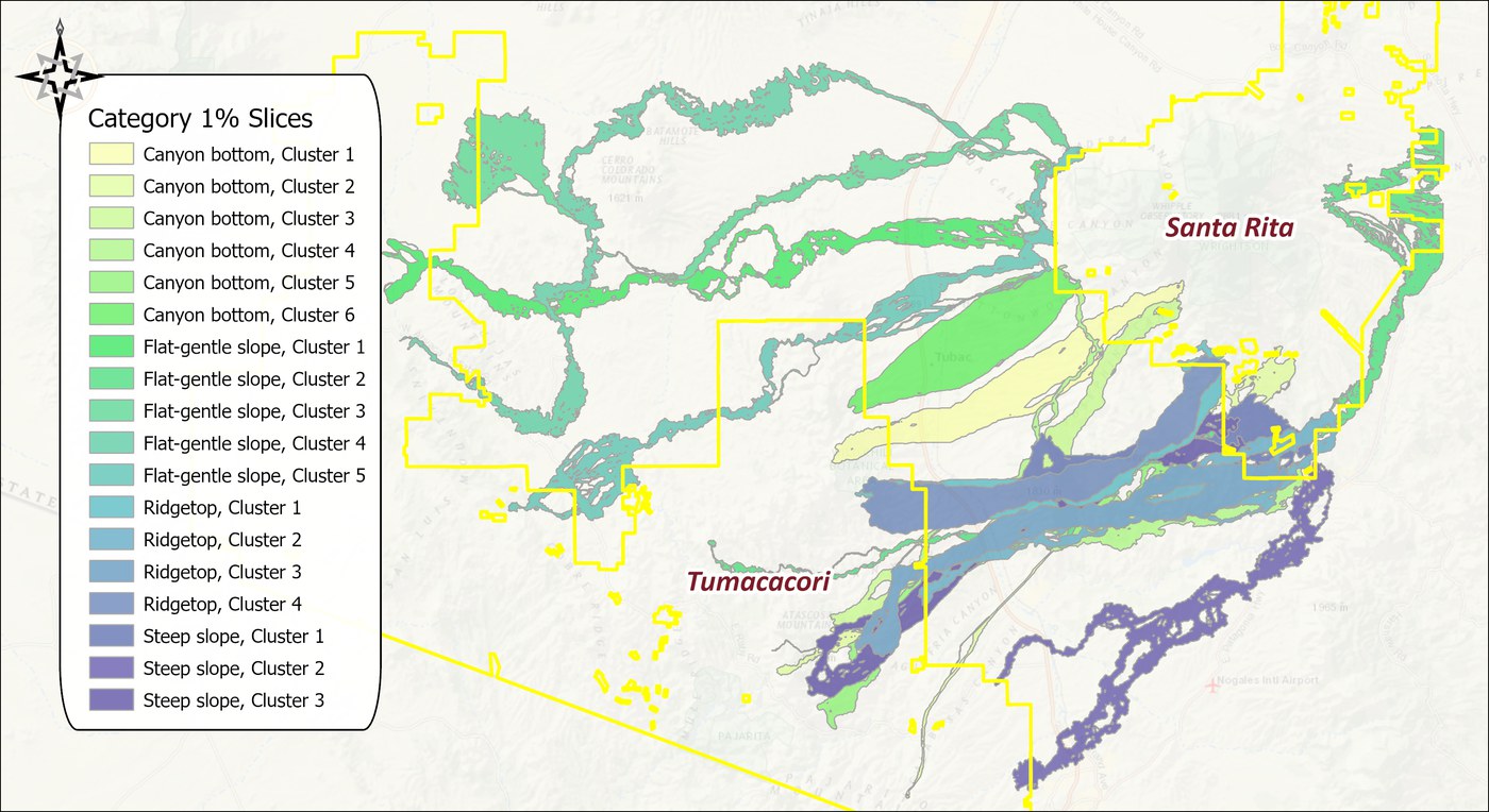 The 1 percent slice of each of the eighteen facet corridors, one color per facet: flat-gentle-slope strands in greens looping far to the north of the Tumacacori block around the Cerro Colorado and Batamote hills, canyon-bottom strands in pale yellows and greens crossing the valley near Tubac, ridgetop and steep-slope strands in blues running southeast along the mountains and south past the Nogales airport, with the wildland blocks outlined in yellow