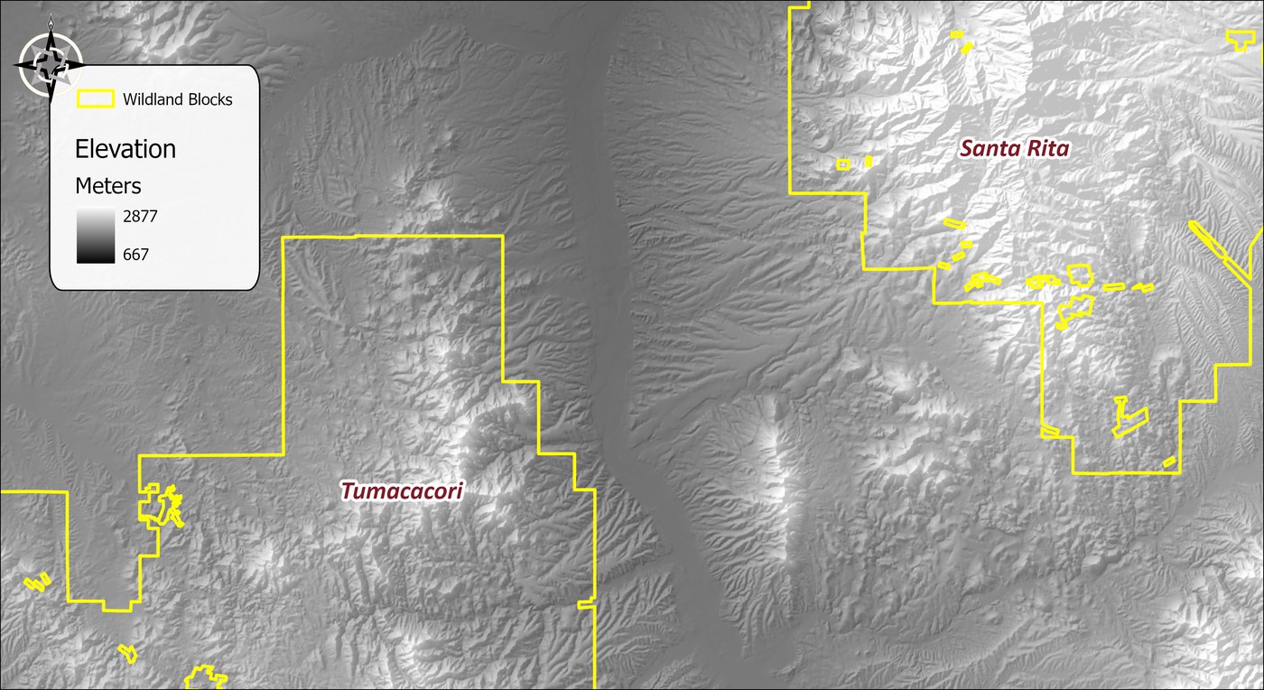 Elevation over the study area as a gray ramp from 667 to 2,877 meters, with the Tumacacori and Santa Rita wildland blocks outlined in yellow