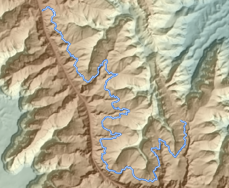 A hillshaded map of a section of the Grand Canyon with two winding trails drawn in blue, each following the contours of the side canyons