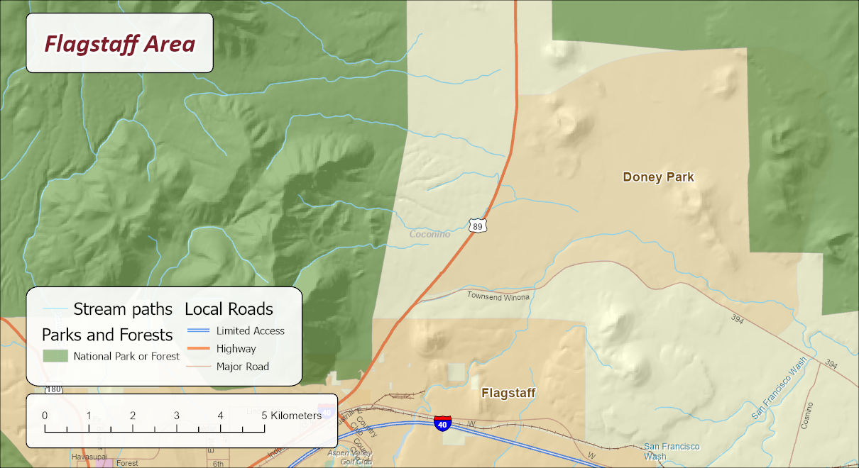 A reference map of the Flagstaff area: national forest in green over hillshaded terrain on the left, the tan Doney Park area and the town of Flagstaff on the right and bottom, US 89 and Interstate 40 in orange and blue, mapped stream paths in light blue, and a 5 kilometer scale bar